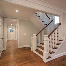 The Beautiful U Shaped Stair Has Hardwood Treads And Handrails With Painted White Risers Newel Post And Pickets Stairs Design Stairs Trim Staircase Design