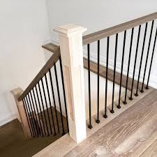 The newels are plain square cut with square caps, while the handrail is the unique pear design. Shaker Craftsman Wood Rail Cap With Iron Balusters And Square Shaker Posts Interior Stair Railing Interior Stairs Stair Railing Design