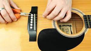 Carefully uncoil a new string and put the ball end into the correct hole of the guitar bridge. How To Change Guitar Strings With Pictures Wikihow