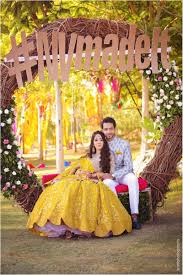 Bright Couple Mehendi Seating With Wreath Indian Wedding Photography Wedding Couples Photography Wedding Photography Poses