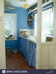 blue checked curtains on cupboard below