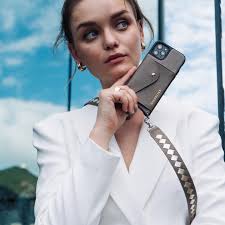 Meet ANGELA ✨Our newest crossbody style! This brand new taupe crossbody  Bandolier features a beautiful repeating gold metallic woven leather strap  detail that will add a signature statement to this neutral iPhone