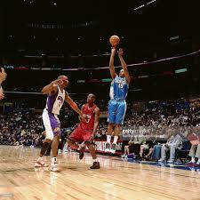 Carmelo Anthony Of The Rookie Team Shoots Against Amare Stoudemire Of Carmelo Anthony Amar E Stoudemire Anthony