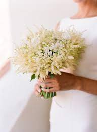 More corsage than bouquet, this style is comprised of a small floral arrangement. One Couple S Cool Modern Garden Wedding In Ojai California Brides Flowers Bouquet Astilbe Wedding Astilbe Bouquet