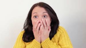 Close-up attractive shocked amazed asian woman touching face in  astonishment and