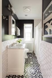 This narrow bathroom gets a boost from its steel blue tiles on the lower half and plain tan shade on the upper wall portion. Narrow Bathroom Design Ideas