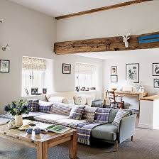 Photo of a rural living room in west midlands with white walls, light hardwood flooring, a wood burning stove, a brick fireplace surround and beige floors. Warm Country Living Room Decorating Ideal Home Living Room Warm Living Room Decor Country Country Living Room
