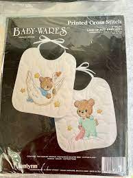 Baby bibs to cross stitch (chart) product no: 380 Stamped Baby Bibs Kits Ideas Baby Bibs Bibs Cross Stitch