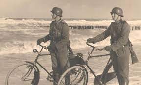German Soldiers Walking Along A Beach With Their Bicycles Cycling Wwii History Military Motorcycle Military History