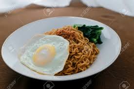 I ndomie is produced by indofood, the pioneer of instant noodles in indonesia and is one of the largest instant noodles manufacturers in the world. Tasty Fried Noodle Indomie Goreng With Sunny Side Up Egg And Stock Photo Picture And Royalty Free Image Image 128567194