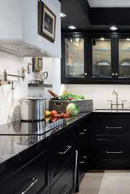 For contrast, the homeowner selected white marble countertops. 30 Sophisticated Black Kitchen Cabinets Kitchen Designs With Black Cupboards