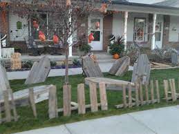 Spider webs can be stretched from the fence to bushes, creating a pathway towards the porch. Halloween Decorations Made From Pallets And Old Privacy Fence Coffins Halloween Fence Halloween Outdoor Decorations Fun Halloween Decor