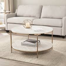 Round Out Your Living Room Table Collection Faux Travertine And Champagne Finish Brings An Air Stone Coffee Table Round Coffee Table Living Room Coffee Table
