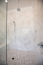 See more ideas about pebble tile, shower tile, bathrooms remodel. Contemporary Bathroom With Walk In Shower With Bench Marble Tile In A Herringbone Pattern And Pebble Large Shower Tile Small Bathroom With Shower Shower Tile
