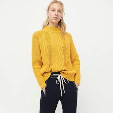 J.crew cable knit sweater in navy blue and cream with navy buttons on both shoulders. J Crew Cable Knit Mockneck Sweater