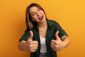 Joyful pretty woman thumbs up with two ...