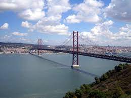 The bridge connects lisbon to almada, the city where you'll find the cristo rei monument. 25th April Bridge Lisbon Lisbon Bridges Portugal Travel Guide