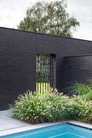To go with the white on a red brick house, i always want to see some black. This Home Combines A Black Brick Exterior With Large Glass Walls For A Strong Contemporary Design