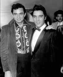 Johnny Cash and Elvis Presley photographed backstage at the Grand Ole Opry,  1957. Cash later wrote in his autobiography: "Elvis was so good. Every show  I did with him, I never missed