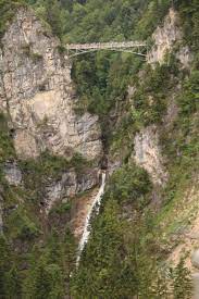 You will walk through füssen old town, pass by schwansee lake, hohenschwanghau castle, admire the neuschwanstein castle from the marienbrücke bridge, climb on top of branderschofen, the summit of tegelberg, descend towards the alpsee lake by passing right near the neuschwanstein castle, surround the alpsee lake and head back to the füssen. Poellat Gorge Waterfall The Falls By Neuschwanstein Castle