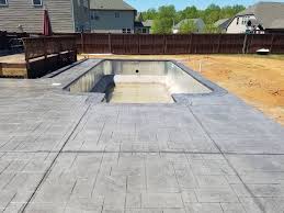 Stamped concrete patio with light gray integral color, dark gray release, and large ashlar slate pattern. Stamped Concrete