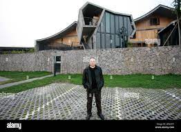 FILE--Chinese architect Wang Shu, owner of the Amateur Architecture Studio,  poses in front of an architecture he designed at the Xiangshan campus of  Stock Photo - Alamy