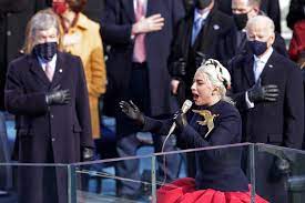 As soon as lady gaga took the stage to perform the national anthem, the comparisons to the hunger games series were immediate. Behold Lady Gaga S Custom Schiaparelli Golden Inauguration Dove Fashionista