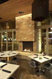 This Intimate Dining Area Features A Roaring Fire With A Mix Of Traditional And Modern Pieces Modern Fireplace Modern Dining Area