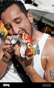 Miami Beach Florida,North Beach,Festival of the Arts,Hispanic man men  male,polish sausage,food,bite,FL070210118 Stock Photo