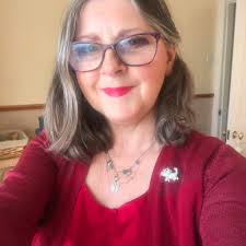 Denim jacket upcycled by replacing sleeves with lace fabric and adding lace  to collar.