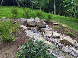 These were arranged so it looked like the water was coming out of a fissure in the rock of the hillside. 7 Ideas For Hillside Landscaping The Revolutionary Gardens Shop