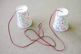 We just tied a knot in the yarn on the inside of the cup to keep it in place. How To Make A Telephone With Paper And Plastic Cups