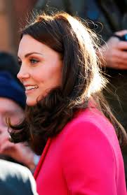 Kate Middleton wraps up baby bump in high street statement coat for day of  charity visits