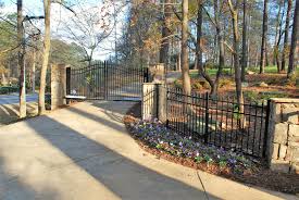 Also, outdoor walkways and paths make your yard more inviting, increase your home's value, and make large yards easier to navigate. Automated Gate System With Stone Walls And Columns Woodstock Apex Fence Company