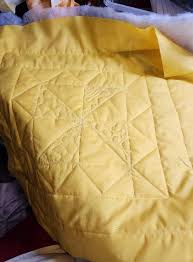 started quilting the blocks...very nervously as I really don't know what  I'm doing here. the stitch in the ditch went ok..the free motion not so  much..very uneven and I'm unsure of my