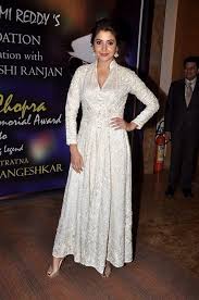 Anushka Sharma White Anarkali Kundan jewellery, hair tied up & red bindi completed her look.