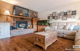 Example of a french country open concept dark wood floor, brown floor, exposed beam, vaulted ceiling and wood ceiling living room design in other with white walls, a standard fireplace and a stone fireplace Remodelaholic Real Life Rooms A Modern Country Living Room Makeover