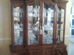 A custom light blue china cabinet is fitted with smoked mirror doors. Reuse An Outdated China Cabinet