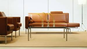 The large plant on the coffee table helps add some lightness to the this leather couch adorned with pillows in natural colors looks like the perfect cozy place to curl up with a good book. Switch Designer Glass Top Tables Coalesse