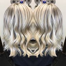 A feathered long blonde hairstyle is another example of a good hair color for women over 50. Icy White Hair Platinum Highlight And Lowlight Olaplex Long Layers Lob Long Hair Highlights Icy Blonde Hair Super Hair