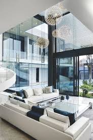 Modern Living Room With Double Height Ceilings With Adorable Chandeliers Kbhome Living Room Design Modern House Styles Modern Interior Design