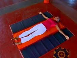 Lying Down Body Twist Natrajasana Art Of Living India Art Of Living Decor Wind Sock