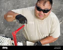 Tech. Sgt. Kyle Kikuchi, Eagle Vision Data Acquisition Segment operator,  levels the leg of a downlink antenna, Clark Air Base, Philippines, Jan. 15,  2017. Kikuchi and approximately 15 other U.S. Airmen and
