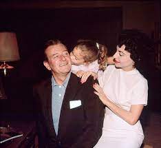 John Wayne at home with his wife Pilar Wayne and their daughter Aissa in  Encino, California, 1958. Photos by Bernie Abramson JohnWayne