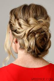 Step 2 / start a dutch braid and continue braiding the front portion of the hair until reaching the left ear. Flower Braid Updo