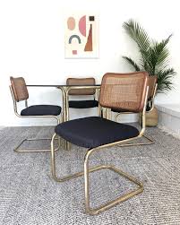 Eastside Gems On Instagram We Ve Got Some Cane Back Cantilever Chairs In A Unique Brass Leather Dining Chairs Modern Dinning Room Chairs Retro Dining Chairs