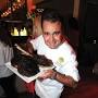 Profile Picture of Chef Aaron Brooks with Signature Tomahawk steak - Brickell Magazineon Google
