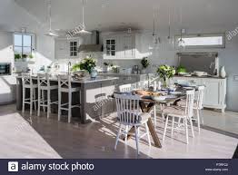 A diy moveable kitchen island prep table. Dining Table By Modern Island Kitchen Stock Photo Alamy