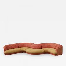 Gently sloping curves and large dual cushions create a favorite lounging spot. Large Mid Century Modern Curved Serpentine Sectional Sofa