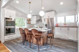 For a smart save, tiffany chose manzoni hardware wood wave pulls that look like they were built into her custom alder cabinets, even though they weren't.tiffany mueller for hello refuge. Crisp White Kitchen With Brass Hardware Midcentury Kitchen New York By Kraftmaster Renovations Houzz